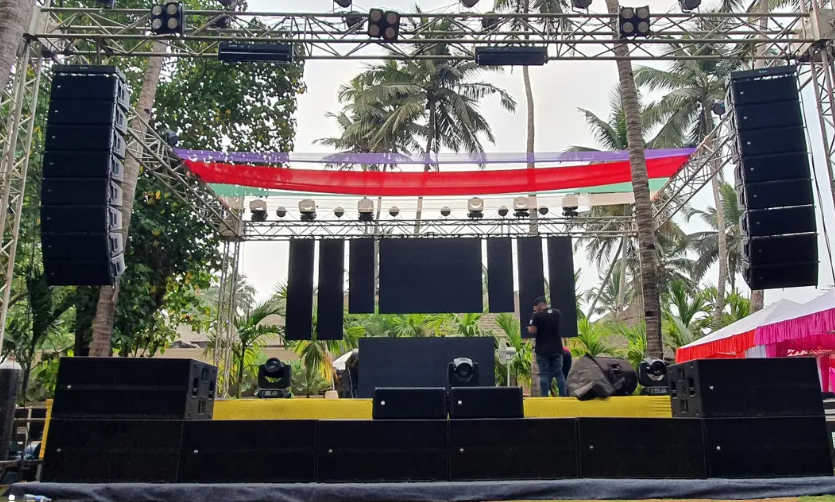 Outdoor stage with trussing, speakers, and lighting
